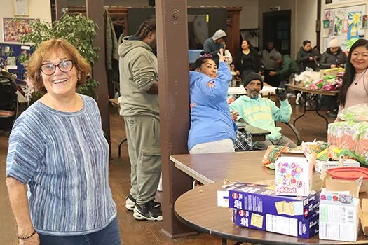 Community members and volunteers gathered at tables at St. Brigid's.